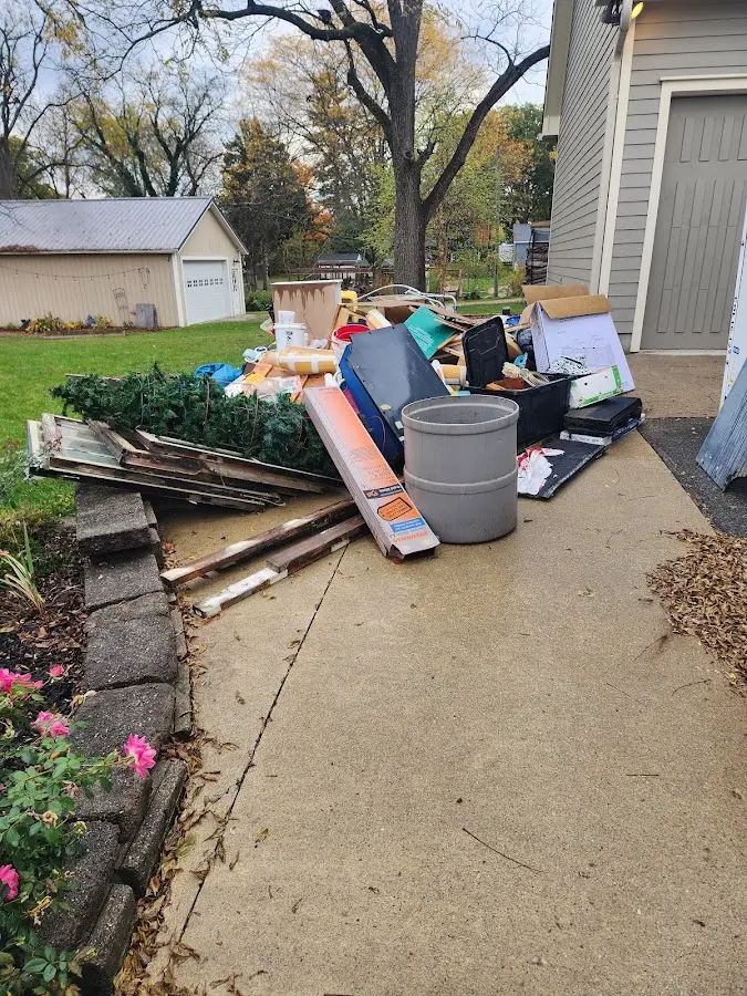 Dumpster being loaded with debris for Estate Cleanout Dumpster Rental in Crane